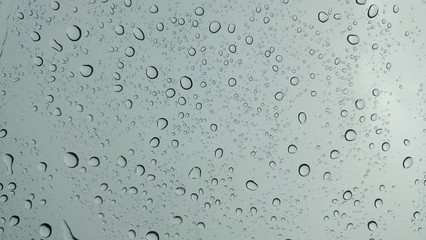 Drops of water on glass in rainy season