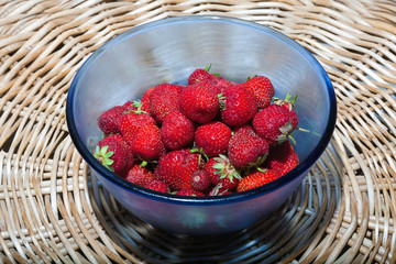 Red strawberries in a blue plate