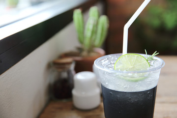 Ice tea with honey and lemon on wooden table