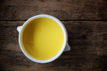 Roasted pumpkin soup on wooden background