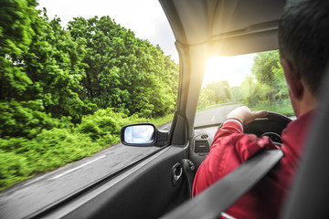 Hands on wheel of a car.