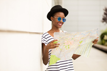 young balck woman looking into a map