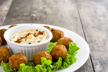 Vegetarian falafels and hummus on a rustic wooden table

