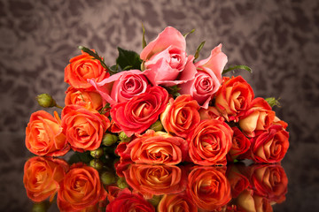 Orange roses on glass table with copy space