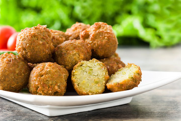 Vegetarian falafels and vegetables on a rustic wooden table

