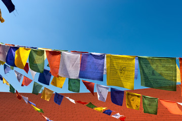 Colorful Buddhist Praying Flags on Blue Sky