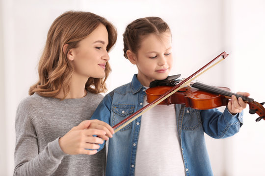 Small Girl Learning Play Violin With Teacher