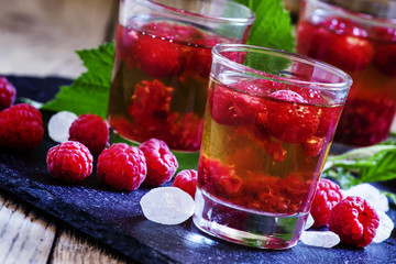 Alcoholic cocktail with whiskey, sugar and raspberries, selectiv