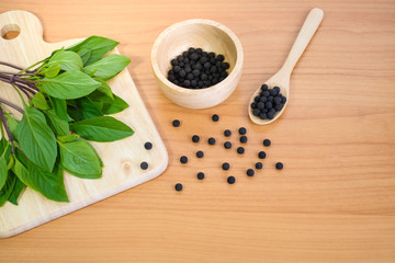 Alternative medicine, herbal pills on wood background.