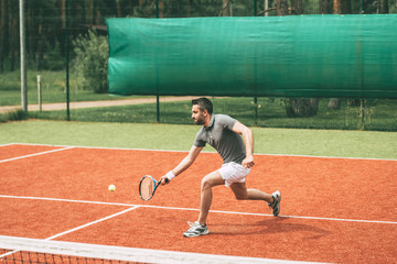 Man playing tennis. 