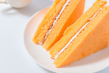 Orange chiffon cake on white background
