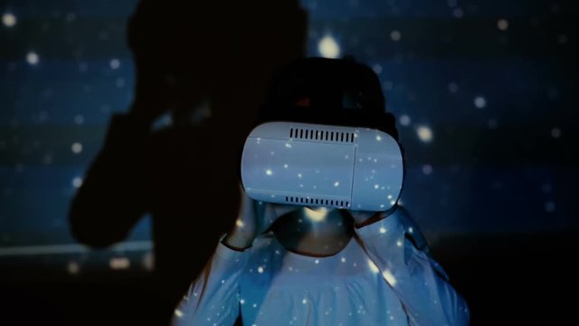 Little girl using augmented reality headset