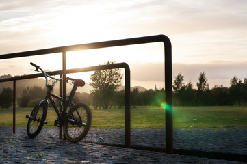 City bike resting at sunset