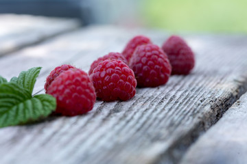 fresh organic berries. raspberries on dark wooden table