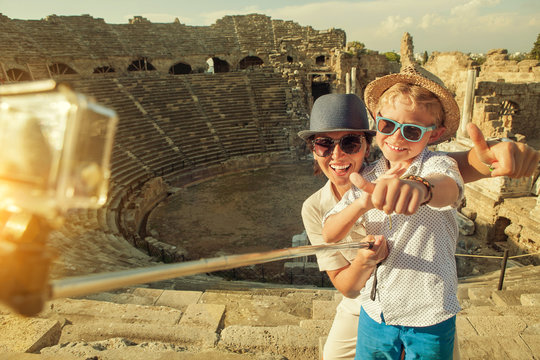 Mother with son take a vacation photo on the Side ampitheatre vi