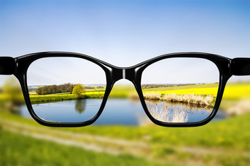 Glasses against natural scenery - 114997959