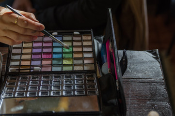 trousse di colori per trucco e make up in fase di lavorazione con mano esperta