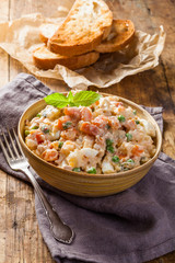 Wooden bowl of traditional russian salad on wooden table