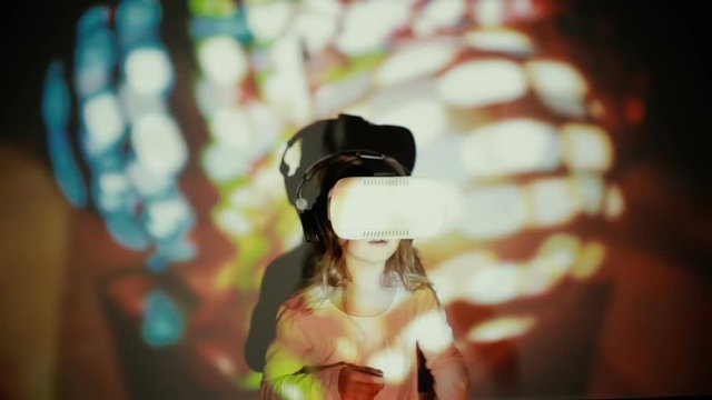 Little girl using VR-helmet. vr dance simulator