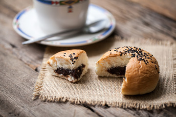 Bread stuffed with black beans on wooden background