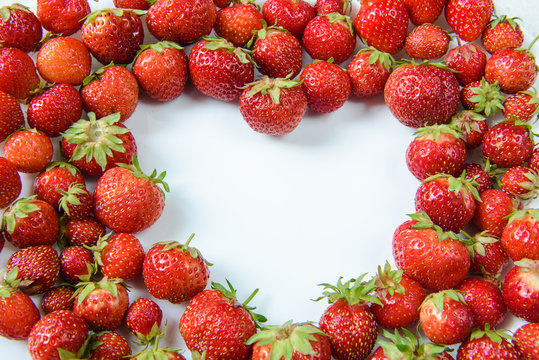 
strawberries laid out on a plate in the form of heart
