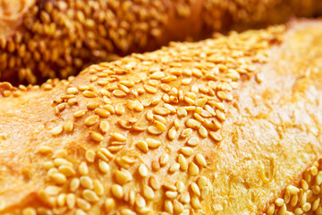 Freshly baked bread with golden crust and sesame seeds, close-up