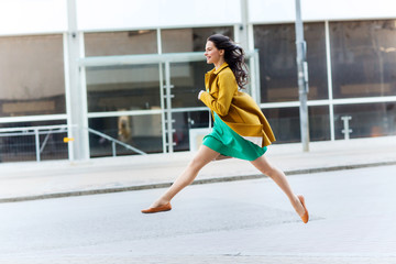 happy young woman or teenage girl on city street