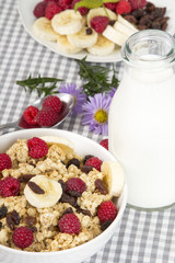 granola with fruits and bottle of fresh milk
