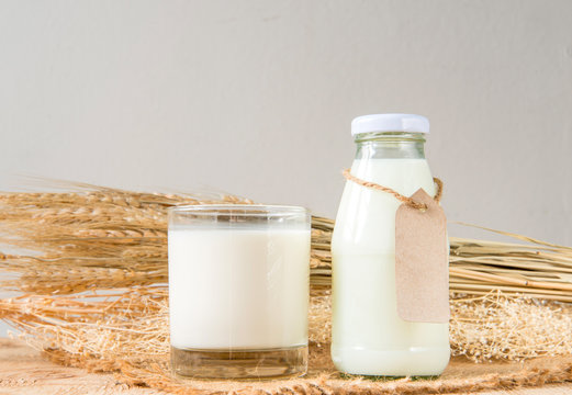 A glass of rustic milk and bottle glass of rustic milk and ear o