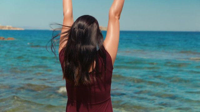 An inspirational shot of a young lady enjoying the sunshine in a Mediterranean island

