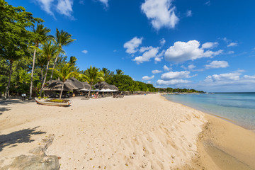 Fototapeta na wymiar Mauritius beach umbrellas, thatch. Tropical Mauritius island water & beach resort, Turtle Bay - Balaclava