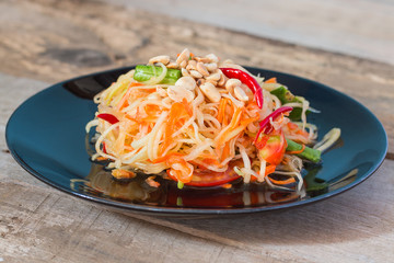 Green Papaya Salad (Som tum Thai) on wood table,Thai food