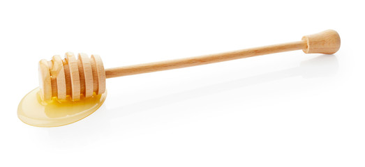 Honey dripping from wooden stick