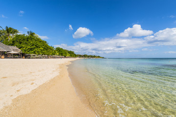 Mauritius beach umbrellas, thatch. Tropical Mauritius island water & beach resort, Turtle Bay - Balaclava