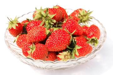 Crystal vase with strawberry isolated on white background