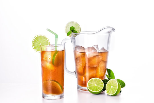 Pitcher and glass with cold ice tea.