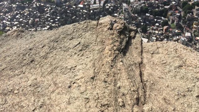 Vertiginous view from a clifflside rock over the crowded Brazilian Rocinha favela shanty town in Rio de Janeiro, Brazil