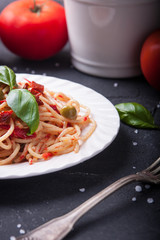 Spaghetti with tomatoes, garlic, basil, olives and olive oil
