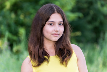 Fototapeta premium Portrait of girl with dark hair on the nature