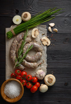homemade raw sausages on a wooden background