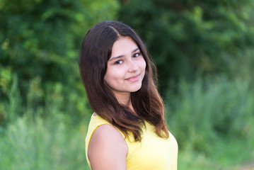 Portrait of girl with dark hair on the nature