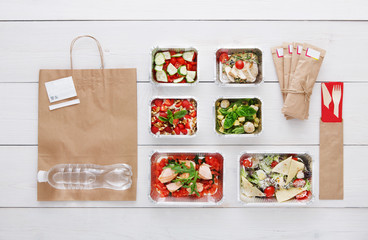 Healthy food take away in boxes, top view at wood