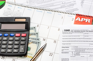 Calculator wth tax form on the calendar
