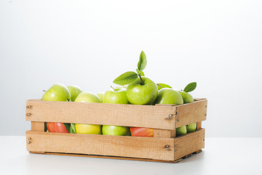 Fresh apples in a wooden box.