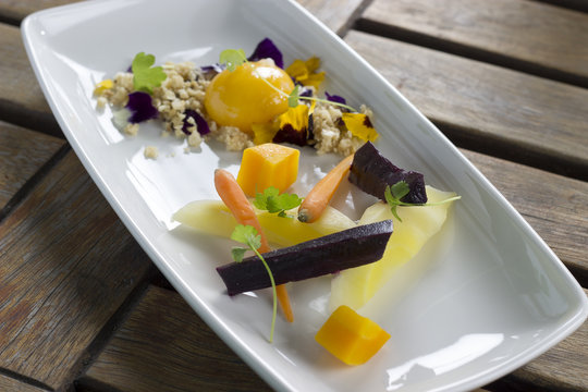 Heirloom carrots with confit egg yolk, hazelnut nasturtium crumble 
