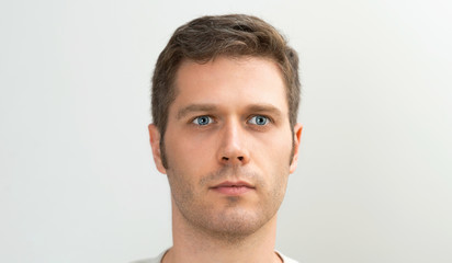 Fototapeta premium Handsome blue-eyed man portrait. Space for your text.