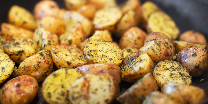 Close-up view of fried potatoes with dill.