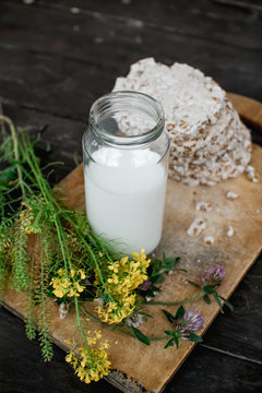Homemade milk and tasty crispbread on wooden table background
