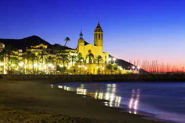 Sunset view of  church at beach. Sitges