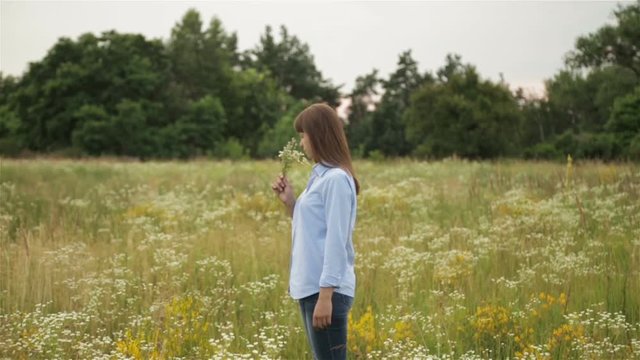 The girl in the meadow with wildflowers